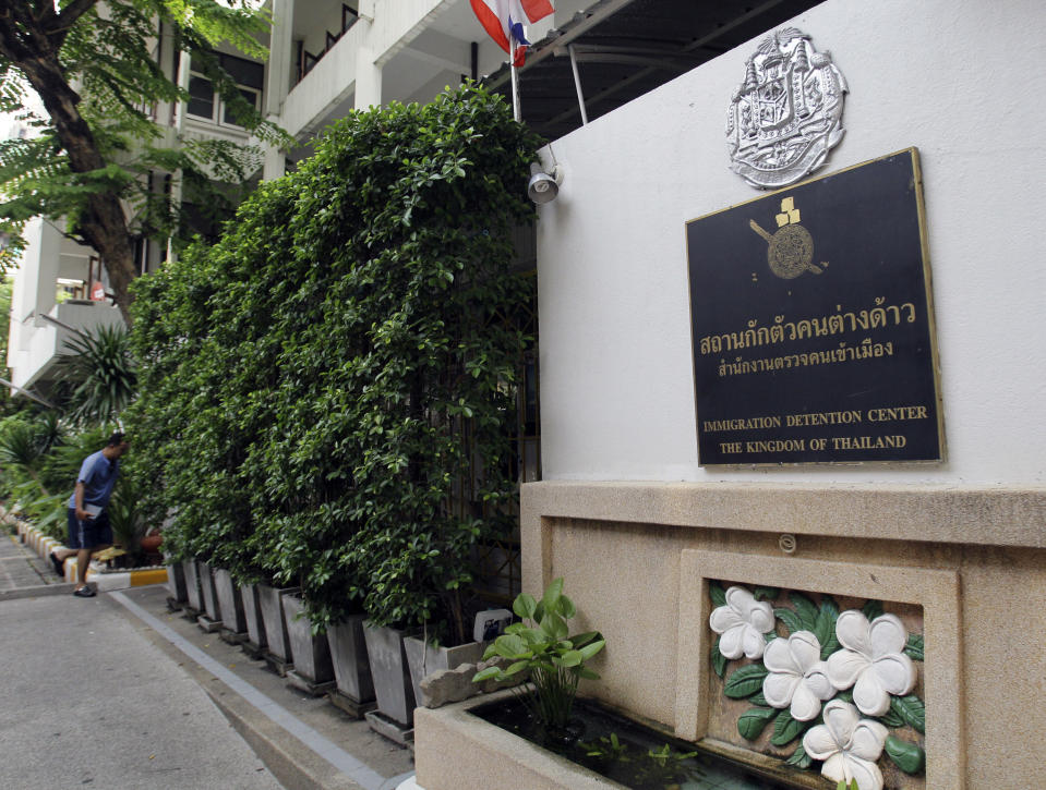 A Thai Immigration official in casual dress walks into Thai Immigration Police detention center in Bangkok Sunday, April 1, 2012, where Vito Roberto Palazzolo, a fugitive Italian banker implicated in the "Pizza Connection" drug and money laundering trial, is being held for questioning. Palazzolo has been detained in Thailand after Italian authorities tracked his whereabouts on Facebook, authorities said Saturday. (AP Photo/Sakchai Lalit)