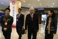 Singapore's Defense Minister Ng Eng Hen, center, arrives for the 10th Beijing Xiangshan Forum in Beijing, Tuesday, Oct. 31, 2023. Ng called on China, as a dominant power in Asia, to take the lead in reducing tensions by being a benevolent one, warning that military conflict like the wars in Ukraine and Gaza would be devastating to the region's future. (AP Photo/Ng Han Guan)