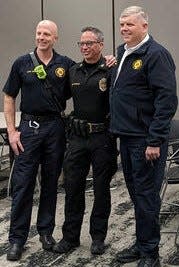 Newtown police chief Tom Synan (center), who spoke at an event at Ohio State-Newark honoring first responders, is flanked by a pair of Newark firefighters.