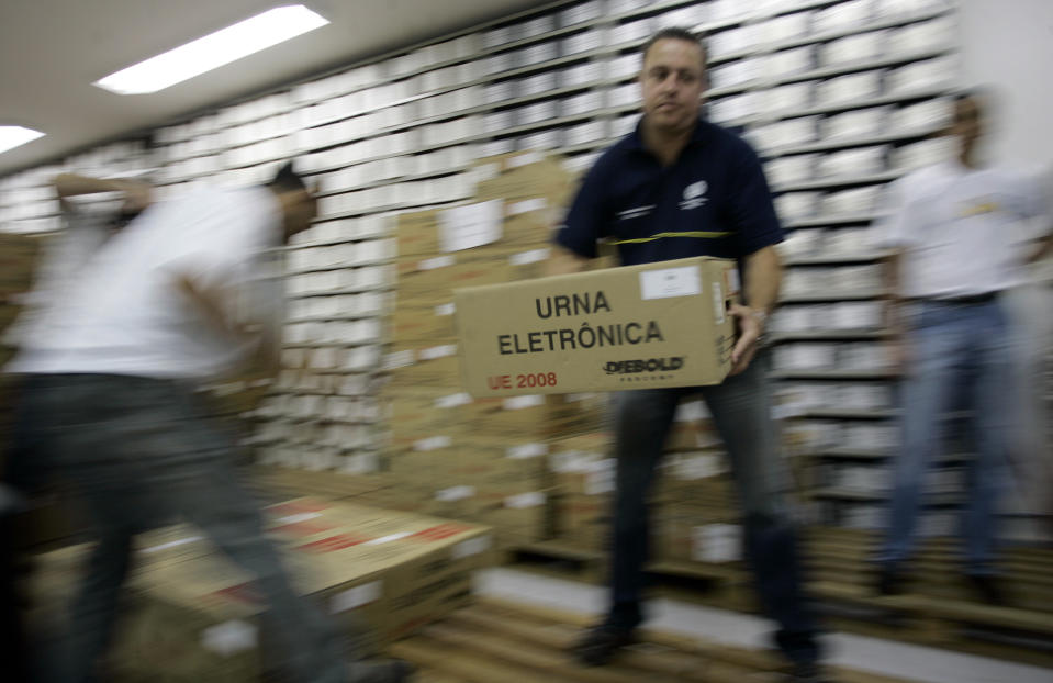 FILE - An electoral worker unload electronic ballot machines to be delivered to polling stations in Sao Paulo, Brazil Oct. 30, 2010 ahead of a presidential election runoff. Brazilian authorities adopted electronic voting machines in 1996 to tackle longstanding fraud. In earlier elections, ballot boxes arrived at voting stations already stuffed with votes. Others were stolen and individual votes were routinely falsified, according to Brazil’s electoral authority. (AP Photo/Nelson Antoine, File)