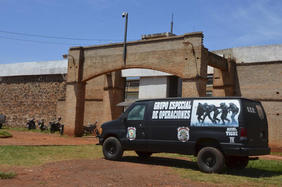 A police van is parked at Pedro Juan Caballero city jail main entrance in Paraguay, Sunday, Jan. 19, 2020. Dozens of inmates escaped from this prison early morning, mostly of Brazil's criminal group PCC, "Capital First Command." (AP Photo/Marciano Candia)