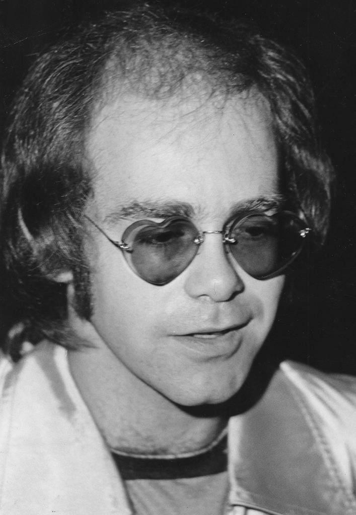 Elton John wearing heart-shaped sunglasses in 1976