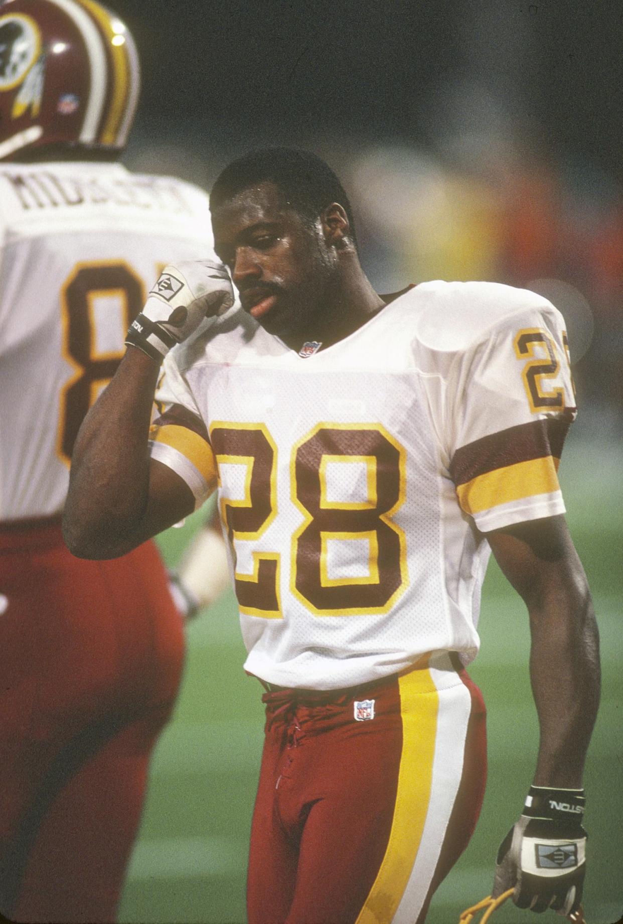 Darrell Green #28 of the Washington football team looks on while walking off the field during an NFL football game circa 1991. (Focus On Sport / Getty Images)