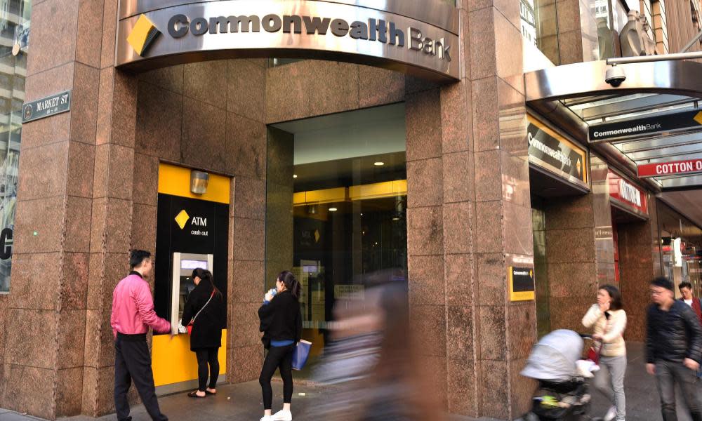 People walk past a Commonwealth Bank branch