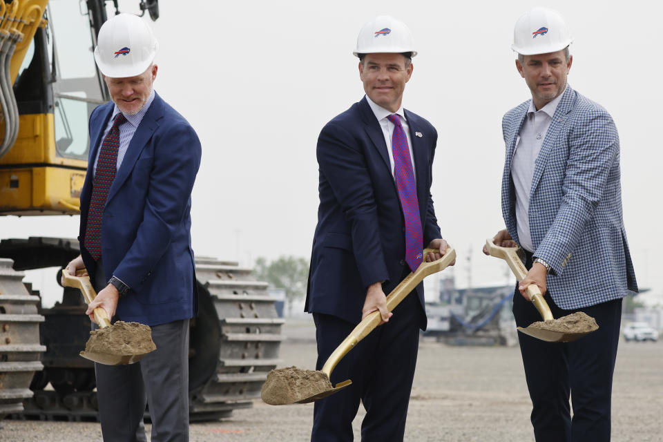 Buffalo Bills head coach Sean McDermott, left, General Manager Brandon Beane and EVP/Chief Operating Officer Ron Raccuia, right, participate in the groundbreaking ceremony at the site of the new Bills Stadium in Orchard Park, N.Y., Monday June 5, 2023. (AP Photo/Jeffrey T. Barnes)