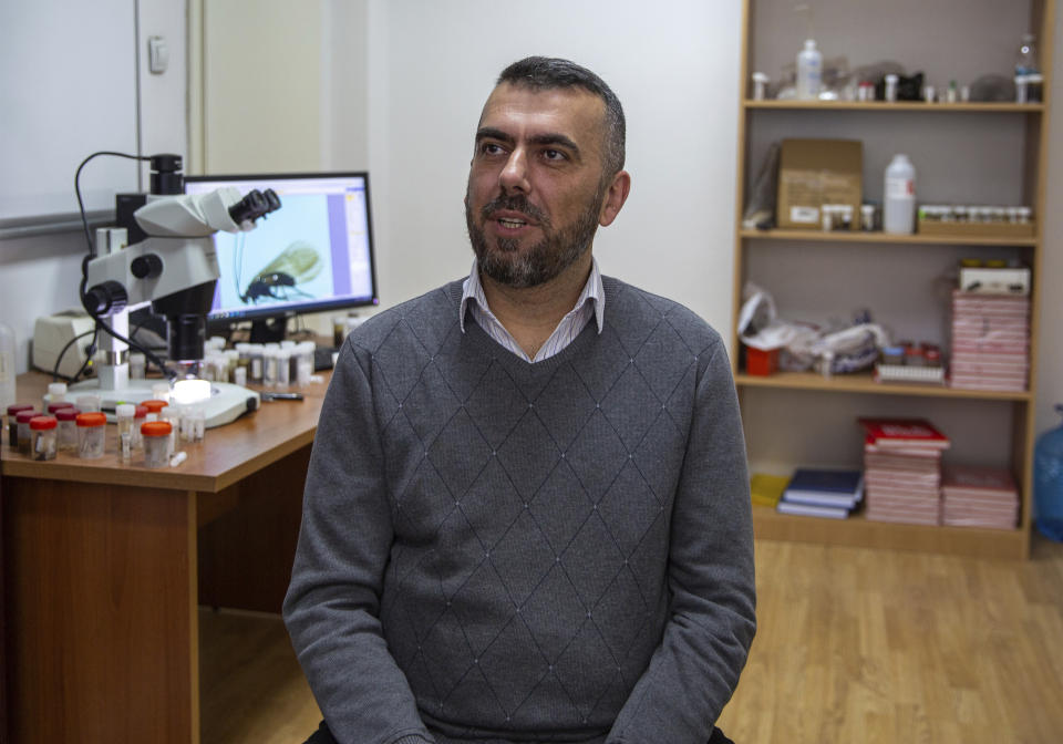 Halil Ibrahimi, 44, associate professor at the faculty of natural sciences at Pristina university, speaks to the media in Pristina on Friday, April 16, 2021. Restrictions during the coronavirus pandemic helped Kosovar biologist Ibrahimi sit down and complete his research, naming a new insect after the virus and raised public awareness against pollution of river basins. (AP Photo/Visar Kryeziu)