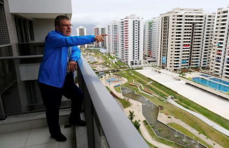 International Olympic Committee (IOC) President Thomas Bach looks from his balcony after moving into the Olympic village in Rio de Janeiro, Brazil, July 28, 2016. REUTERS/Ivan Alvarado