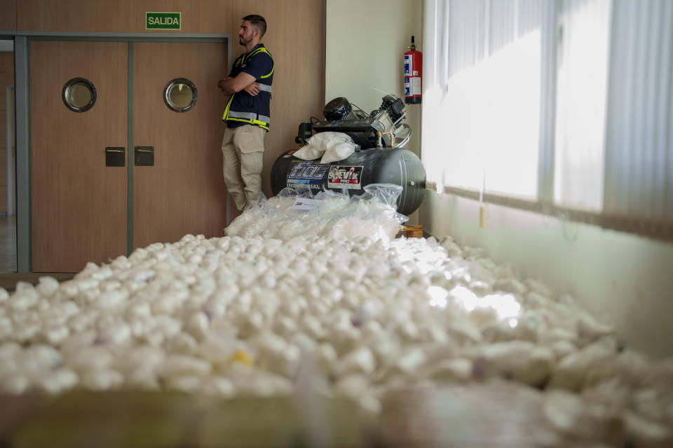 A police officer stands by part of a haul of 1.8 tons of methamphetamine in Madrid, Spain, Thursday, May 16, 2024. Spanish police say they have dismantled a major methamphetamine distribution network of the Mexican Sinaloa cartel after making a bust of 1.8 tons of the illegal drug. (AP Photo/Manu Fernandez)