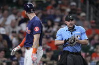 Houston Astros' Kyle Tucker, left, speaks to umpire Quinn Wolcott after being called out on strikes during the third inning of a baseball game against the Seattle Mariners Saturday, May 4, 2024, in Houston. (AP Photo/Kevin M. Cox)