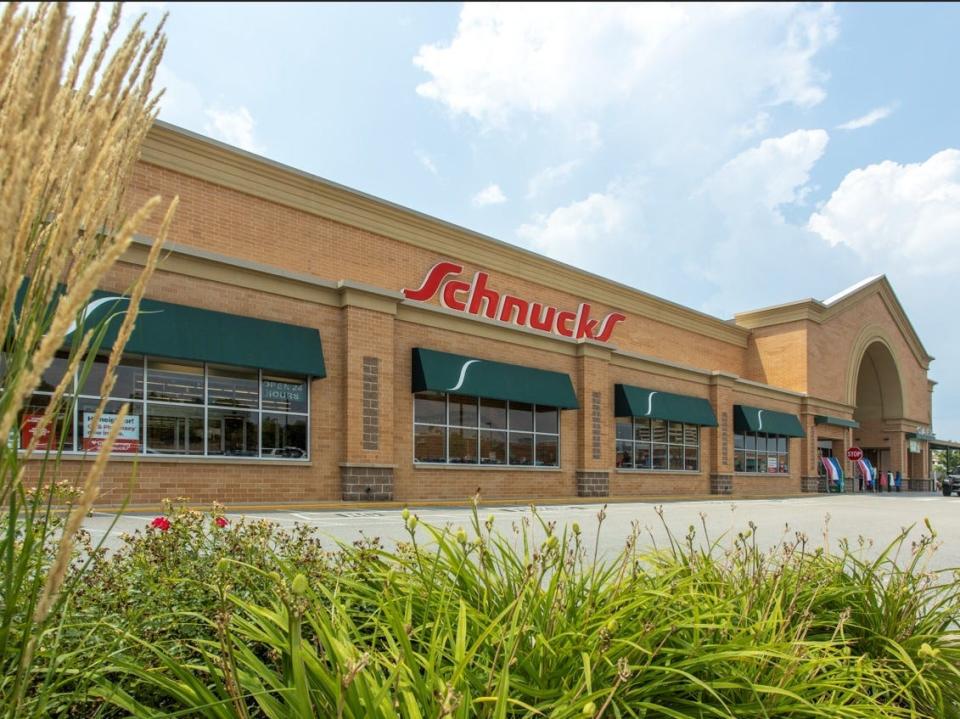 The entrance of a Schnucks supermarket, featuring tan bricks and the red "Schnucks" logo