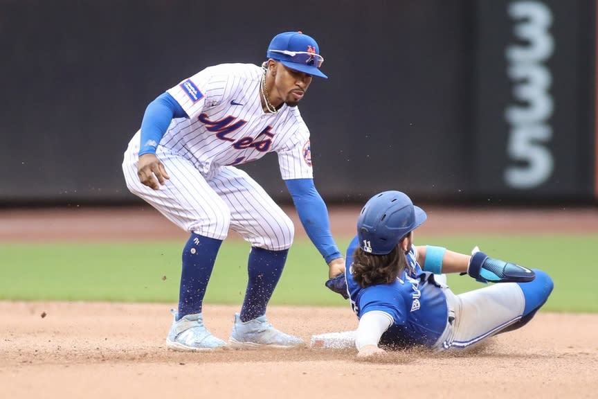 New York Mets shortstop Francisco Lindor (12) tags out Toronto Blue Jays shortstop Bo Bichette (11) in the fifth inning at Citi Field.