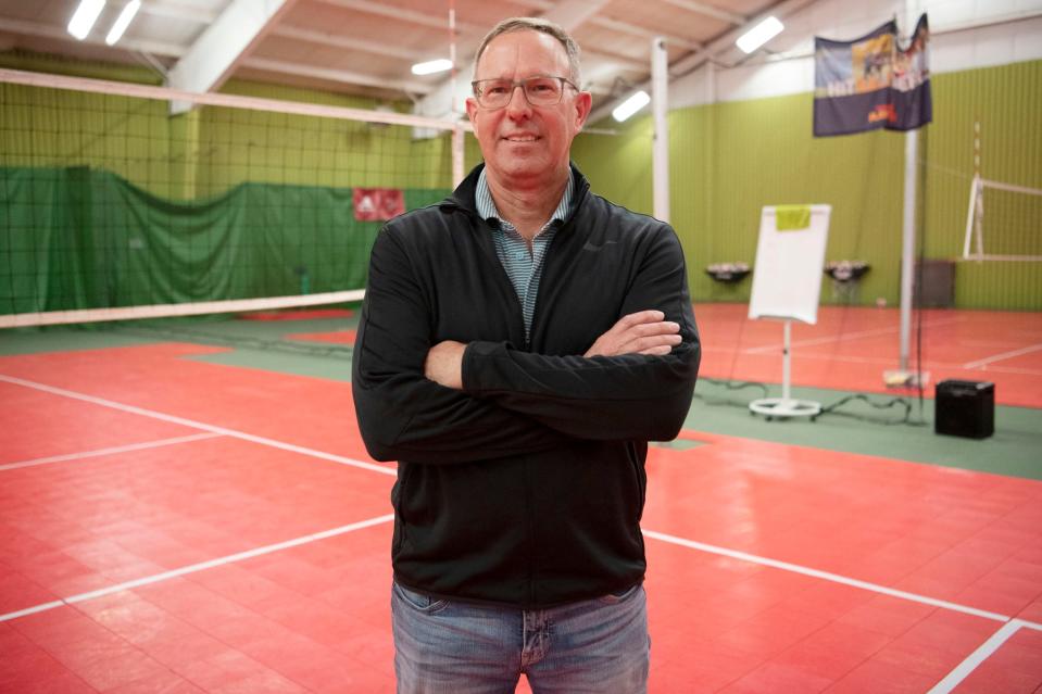 Mark Harvey, owner of Minges Creek Athletic Club, stands for a portrait on the volleyball court in Battle Creek, Michigan on Thursday, April 14, 2022.