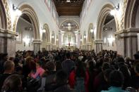 People attend the funeral of several of the victims killed by shooters at a slot-machine arcade in the central Mexican state of Michoacan, in Uruapan