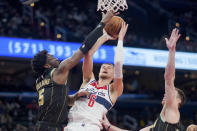 Charlotte Hornets center Mark Williams (5) blocks a shot by Washington Wizards center Kristaps Porzingis (6) during the first half of an NBA basketball game Wednesday, Feb. 8, 2023, in Washington. (AP Photo/Jess Rapfogel)