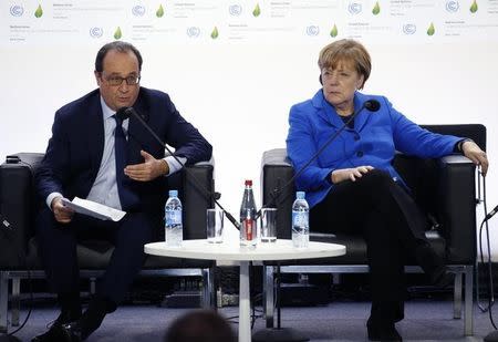 German Chancellor Angela Merkel (R) and French President Francois Hollande attend a meeting on Carbon Pricing on the opening day of the World Climate Change Conference 2015 (COP21) at Le Bourget, near Paris, France, November 30, 2015. REUTERS/Jacky Naegelen