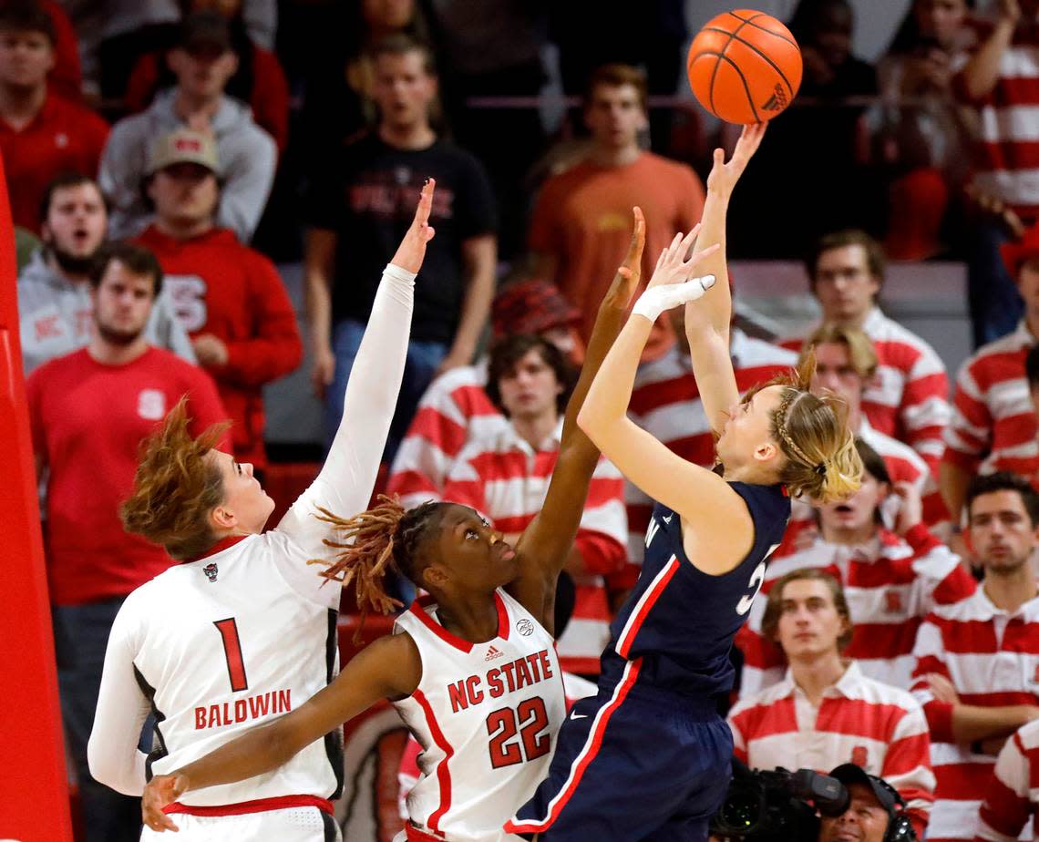 UConn’s Paige Bueckers shoots over N.C. State’s River Baldwin and Saniya Rivers during the second half of the Wolfpack’s 92-81 win on Sunday, Nov. 12, 2023, at Reynolds Coliseum in Raleigh, N.C.