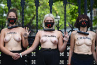 NOTE NUDITY Topless Extinction Rebellion protesters chained to the gates of the Houses of Parliament, London, on the last day of demonstrations.