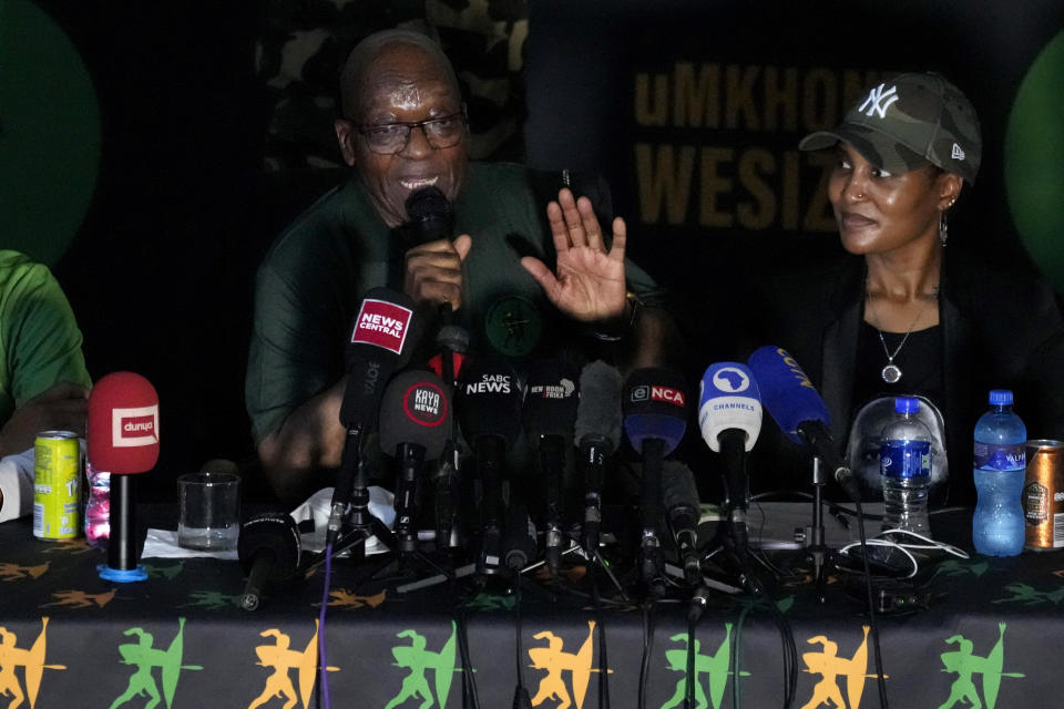 Former South African President Jacob Zuma, centre speaks as his daughter Duduzile Zuma-Sambudla listens, during a press conference in Soweto, South Africa, Saturday, Dec. 16, 2023. Zuma has denounced his ruling African National Congress party and announced that he will vote for a newly-formed political formation in the country's general election next year. (AP Photo/Themba Hadebe)