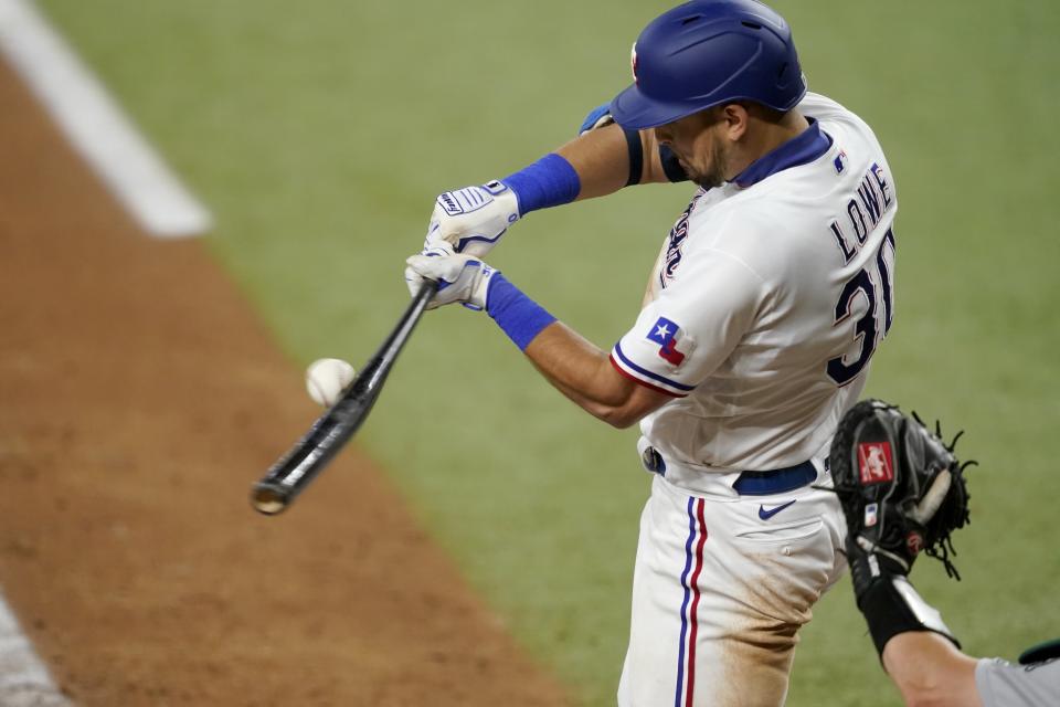 Texas Rangers' Nathaniel Lowe connects for an RBI-single in the sixth inning of the team's baseball game against the Oakland Athletics in Arlington, Texas, Saturday, Aug. 14, 2021. Yonny Hernandez scored on the hit. (AP Photo/Tony Gutierrez)