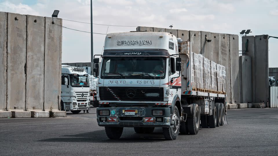 Cargo trucks carrying humanitarian aid move through security inspections before crossing into the Gaza Strip, in Kerem Shalom, Israel on March 14. - Marcus Yam/Los Angeles Times/Getty Images