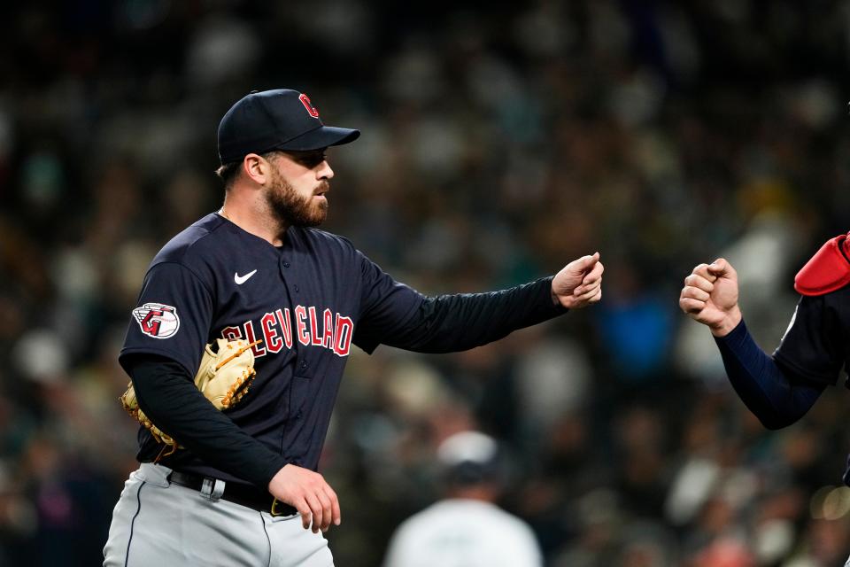 Guardians starting pitcher Aaron Civale greets catcher Cam Gallagher after the seventh inning against the Mariners on Saturday, April 1, 2023, in Seattle.