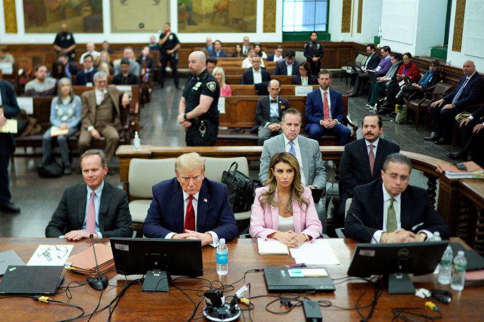 Donald Trump sits at the defense table at his New York fraud trial, flanked, from left, by attorneys Chirstopher Kise, Alina Habba, and Clifford Robert.