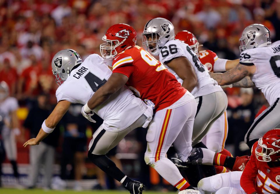 Raiders QB Derek Carr gets sacked by Chiefs defensive tackle Chris Jones during the second quarter. Jones was called for a penalty for roughing the passer.