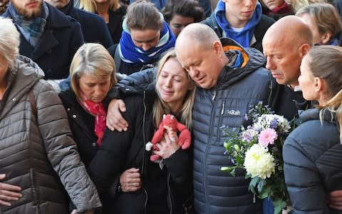 Leanne O'Brien, the girlfriend of Jack Merritt, is comforted by family members during a vigil at The Guildhall in Cambridge  - Credit: SWNS