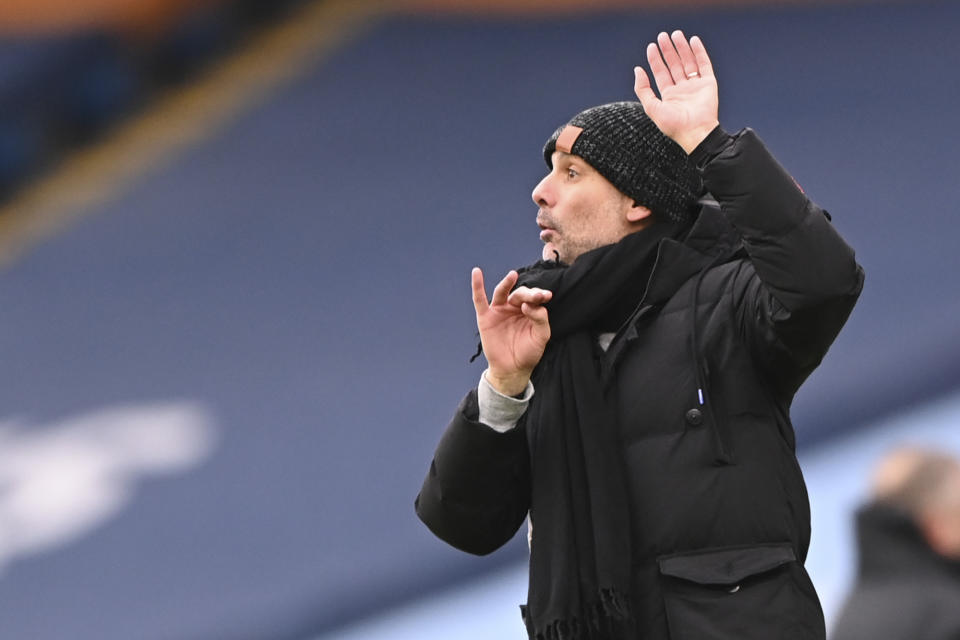 Manchester City's head coach Pep Guardiola reacts during the English Premier League match between Manchester City and Sheffield United at the the City of Manchester Stadium in Manchester, England, Saturday, Jan. 30, 2021. (Laurence Griffiths/Pool via AP)