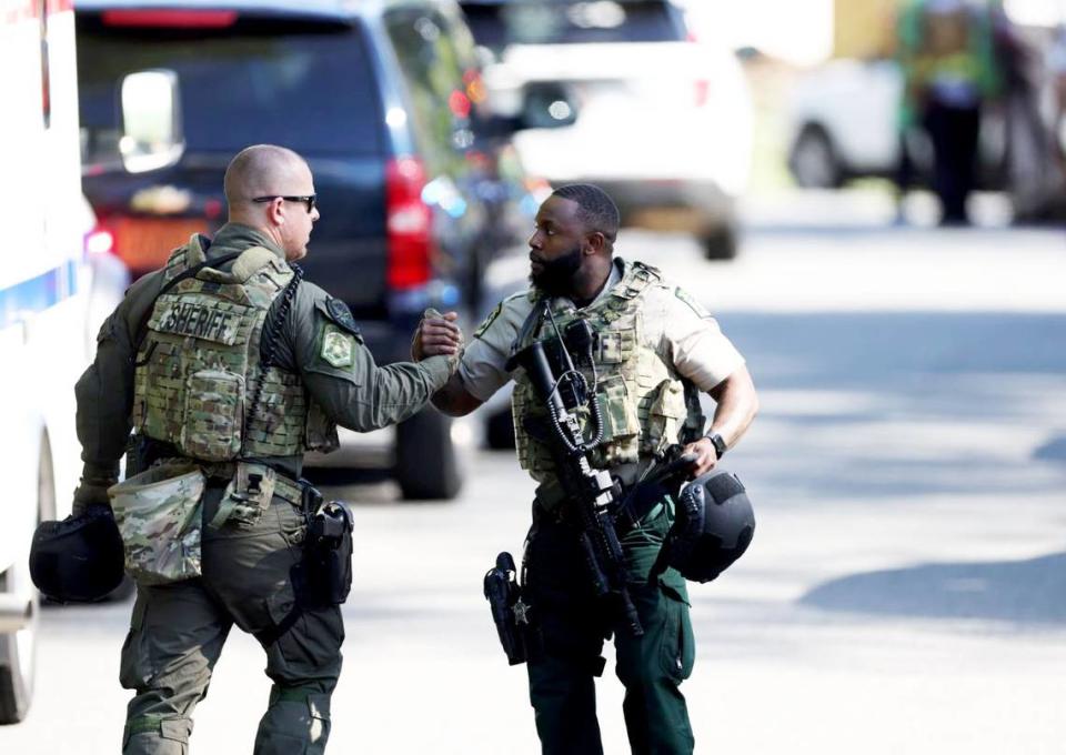 Sheriff members greet each other at the scene of a shooting where multiple law enforcement officers were shot Monday in east Charlotte, NC on Monday, April 29, 2024