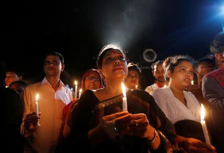 People attend a candle light vigil for the victims of the attack on the Holey Artisan Bakery and the O'Kitchen Restaurant, in Dhaka, Bangladesh, July 3, 2016. REUTERS/Adnan Abidi
