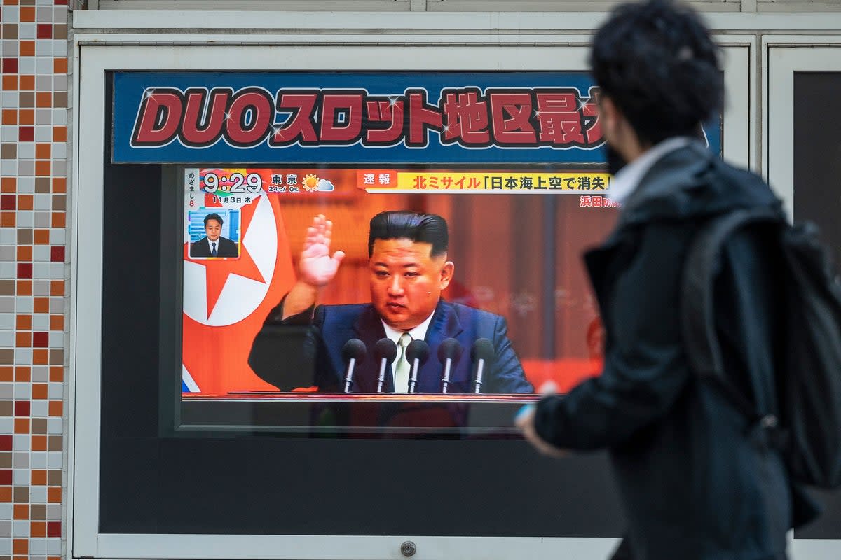 File: A man walks past a television screen showing a news report with images of the North Korean leader Kim Jong-un along a pedestrian walkway in Tokyo (AFP via Getty Images)