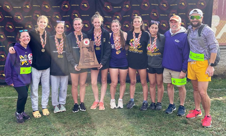 Smithsburg's girls cross country team poses with the 2023 Maryland Class 1A state championship trophy.