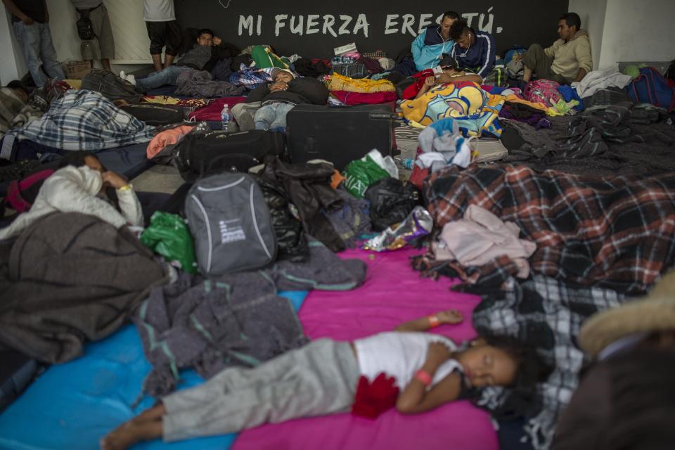 Central American migrants rest in a temporary shelter in Queretaro, Mexico, Saturday, Nov. 10, 2018. Thousands of Central American migrants were back on the move toward the U.S. border Saturday, after dedicated Mexico City metro trains whisked them to the outskirts of the capital and drivers began offering rides north. (AP Photo/Rodrigo Abd)