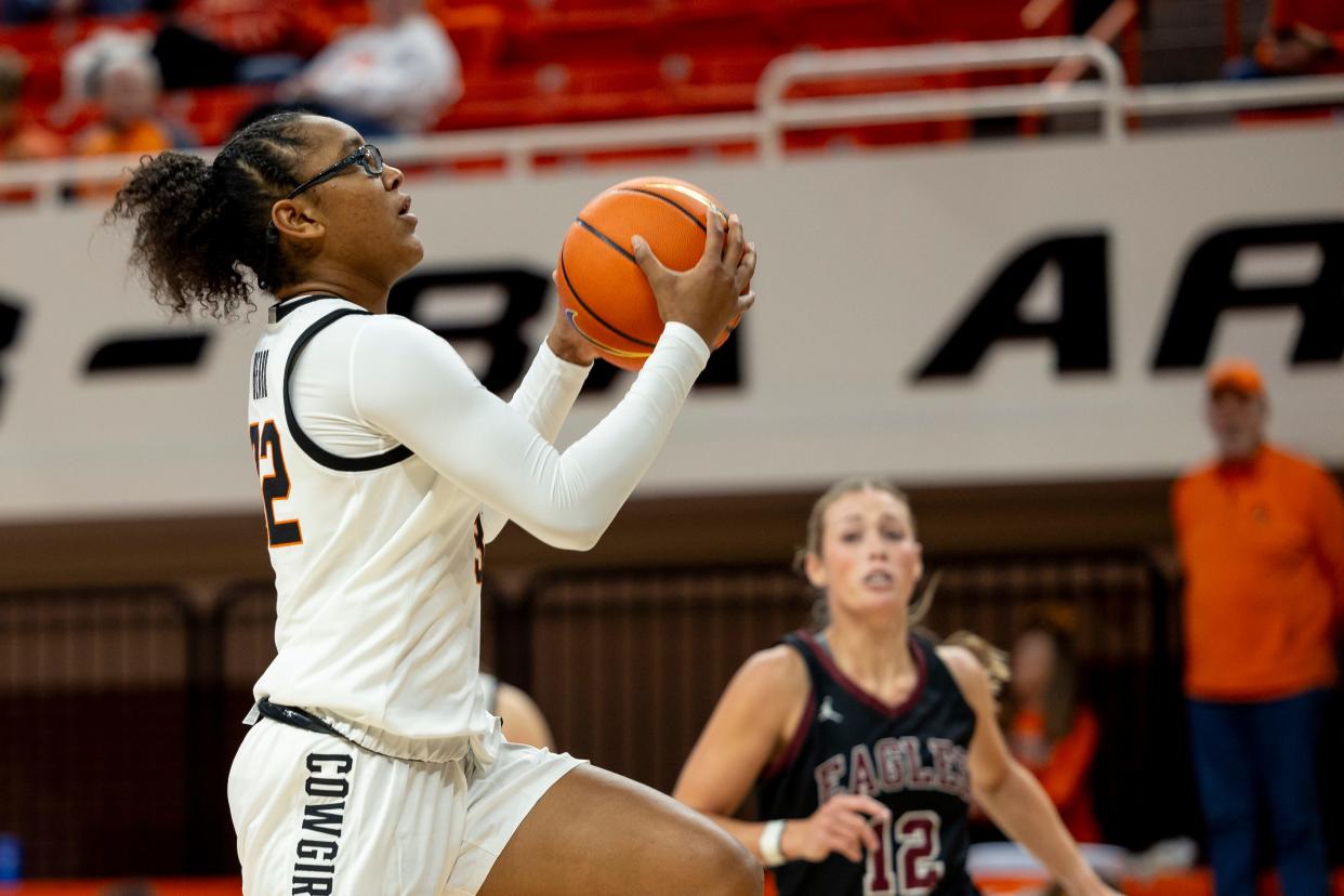 Oklahoma State 's Stailee Heard layups the ball over Oklahoma Christian's Brooklin Bain (12) during the forth quarter of a womenÕs college basketball game Tuesday, Oct. 31, 2023, in Stillwater, Okla. (Mitch Alcala for the Oklahoman)