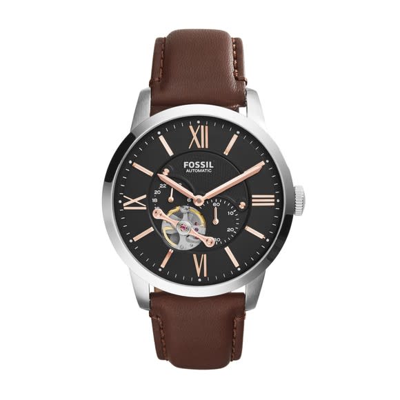 Fossil's Orologi Meccanici watch with a brown leather strap.