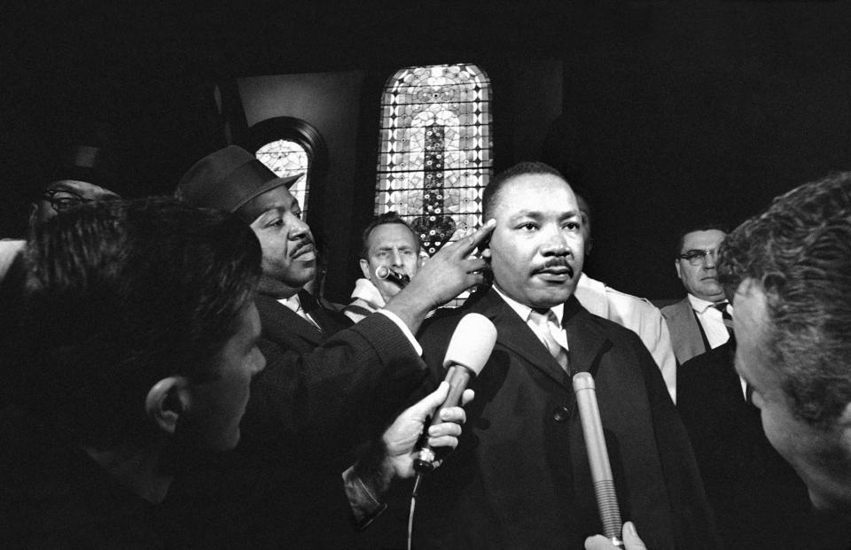 Civil rights leader Ralph Abernathy points to the spot where Dr. Martin Luther King was struck in Selma, Alabama on Jan. 18, 1965 as King attempted to register at a formerly white hotel.