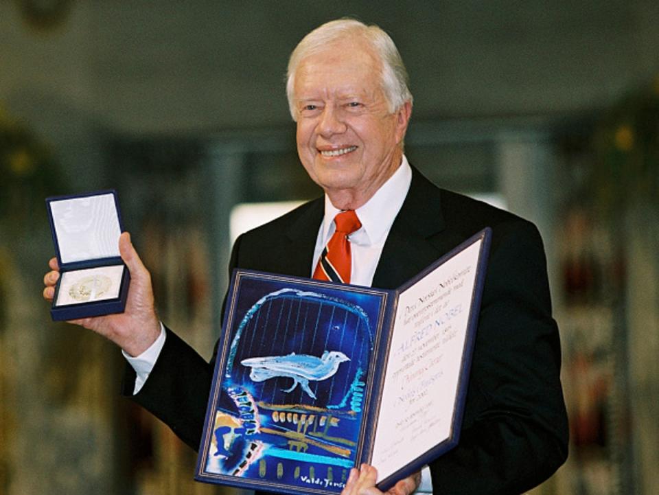 Former president Jimmy Carter holds up his Nobel Peace Prize December 10, 2002 in Oslo, Norway.  His granson said he is no longer awake every day while in hospice care. (Getty Images)