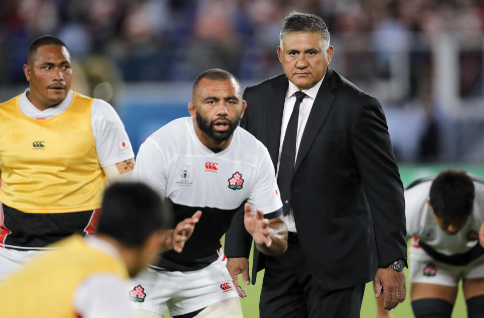 Japan coach Jamie Joseph watches his players warm up ahead of the Rugby World Cup Pool A game at International Stadium between Japan and Scotland in Yokohama, Japan, Sunday, Oct. 13, 2019. (AP Photo/Christophe Ena)