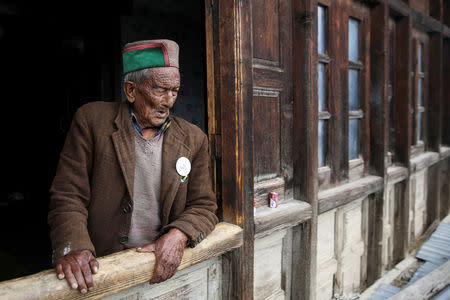 Shyam Saran Negi, 102, independent India's first voter who has participated in all elections since 1951, looks out from his house ahead of the final phase of the general election, in Kalpa, India, May 18, 2019. REUTERS/Cheena Kapoor