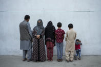 Najia, second left, pose with her family in Kabul, Afghanistan, Friday, Oct. 1, 2021. Soon after the Taliban took control of Kabul, the family sold their households and used the money to unsuccessfully cross into Pakistan. Najia, once a bacha posh, believes there is no place for them under the current regime. Bacha posh means in Dari "dressed up as a boy" and is a regional tradition that allowed parents to dress and raise their daughters as boys with the goal to provide them with a different life. (AP Photo/Bernat Armangue)