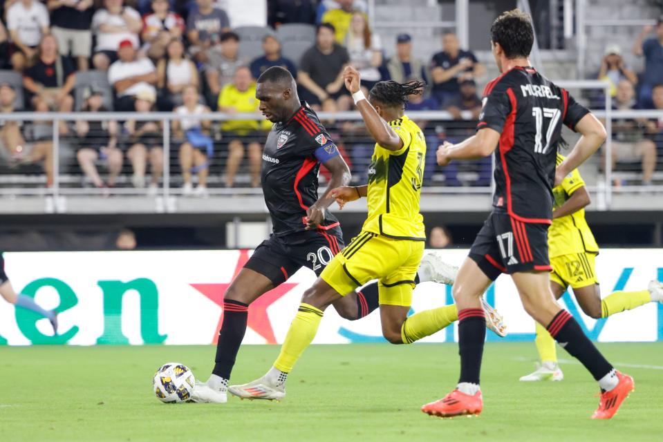 Sep 28, 2024; Washington, District of Columbia, USA; D.C. United forward Christian Benteke (20) scores a goal past Columbus Crew defender Steven Moreira (31) during the second half at Audi Field. Mandatory Credit: Amber Searls-Imagn Images