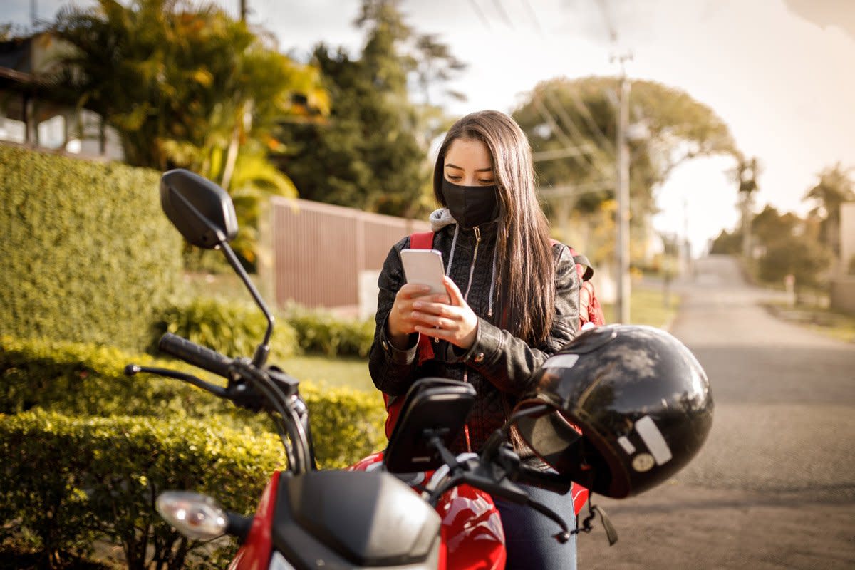 A woman tracks her mileage while on her motorcycle. 