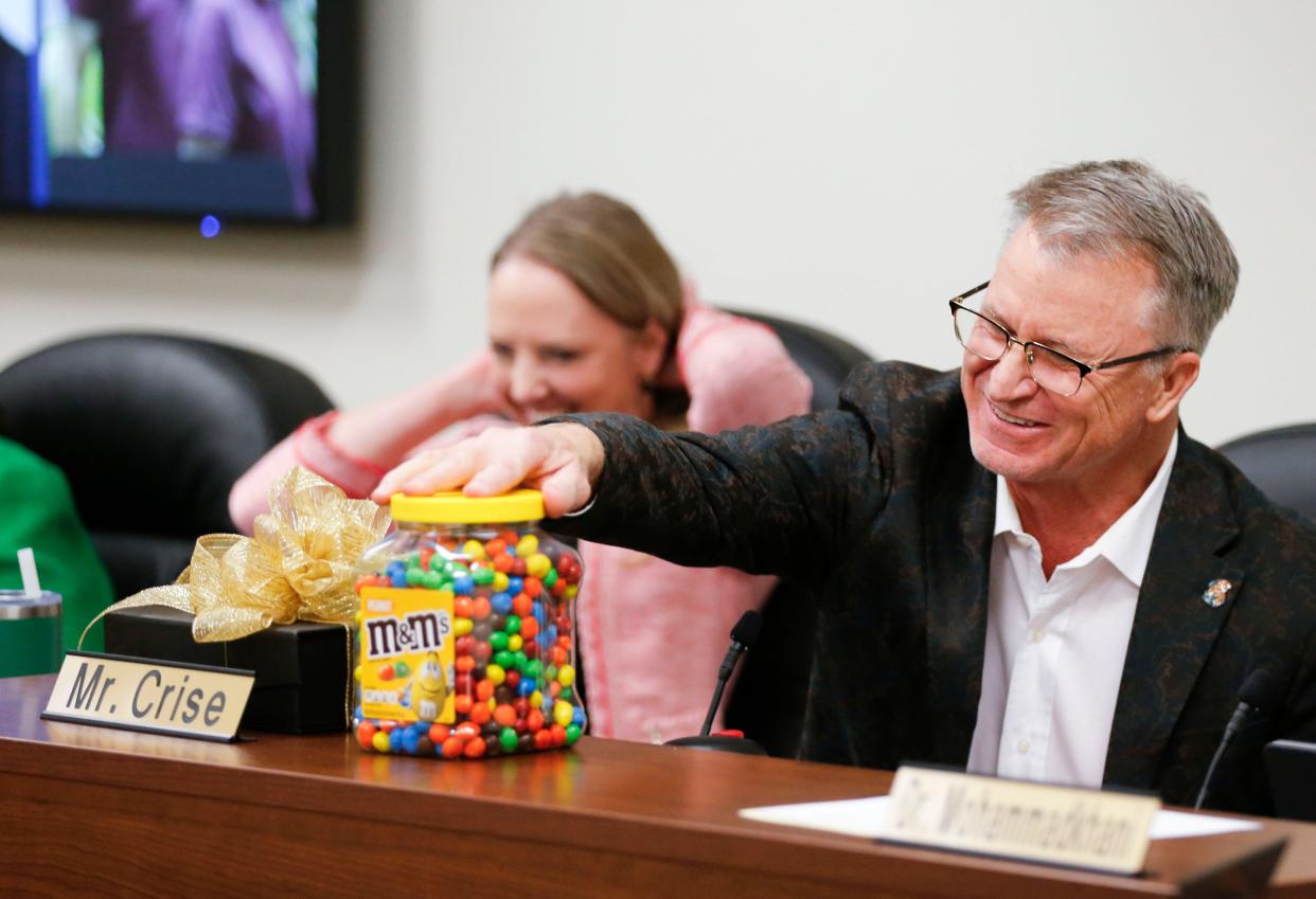 Springfield school board member Kelly Byrne gave Scott Crise a large container of peanut M&Ms as a parting gift during the April 9 meeting.