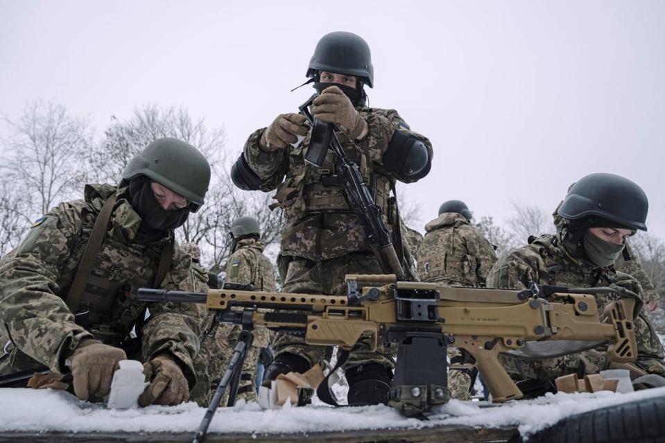 Members of the Siberian Battalion prepare weapons during military exercises with the International Legion of the Armed Forces of Ukraine at an undisclosed location in Ukraine, in December 2023. (Andrew Kravchenko/Bloomberg via Getty Images)