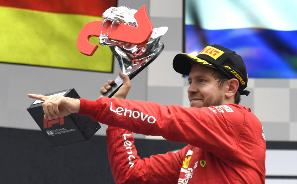 Ferrari driver Sebastian Vettel of Germany celebrates on the podium after he placed second in the German Formula One Grand Prix at the Hockenheimring racetrack in Hockenheim, Germany, Sunday, July 28, 2019. (AP Photo/Jens Meyer)