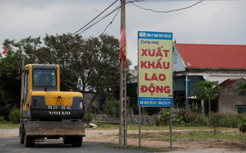 An advertising billboard of a labour export company is seen outside Formosa steel mill in Ha Tinh province