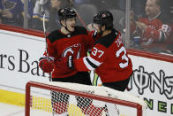 New Jersey Devils right wing Joey Anderson (14) celebrates with center Pavel Zacha (37) after scoring during the third period of an NHL hockey game against the St. Louis Blues, Friday, March 6, 2020, in Newark. (AP Photo/John Minchillo)
