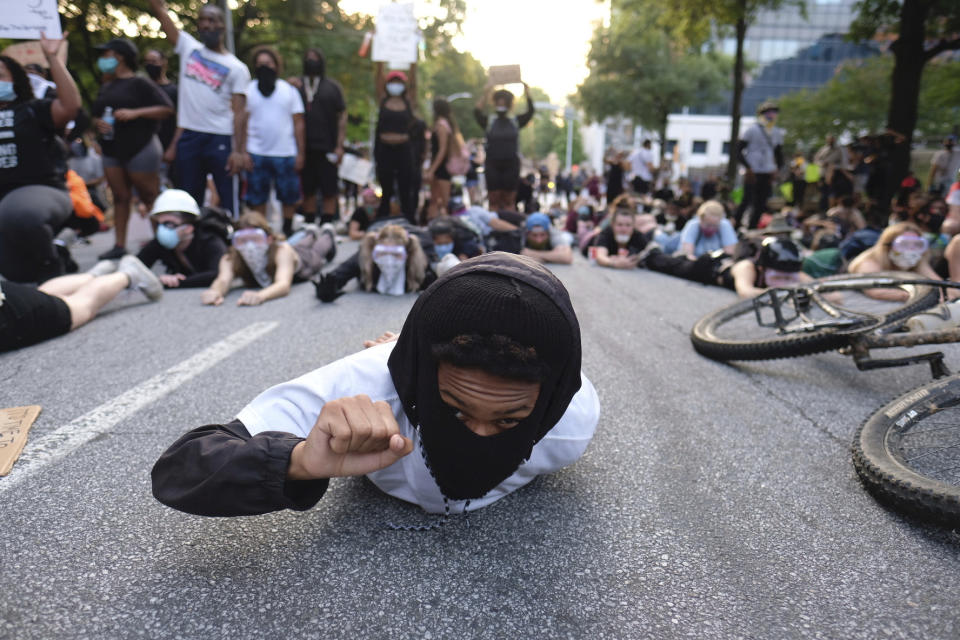 Protesters lie on a street during a demonstration Monday, June 1, 2020, in Atlanta over the death of George Floyd, who died May 25 in Minneapolis. (Ben Gray/Atlanta Journal-Constitution via AP)