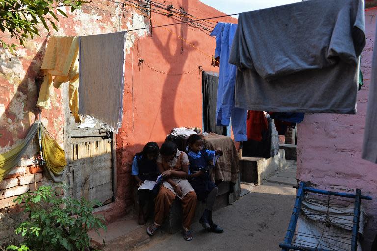 Ganga Kalshetty (C), 12, diagnosed with the early signs of leprosy, sits with her friends as they study in a leprosy colony in New Delhi